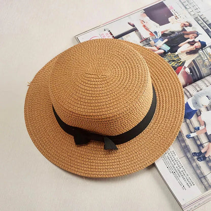 A classic summer Panama hat made from straw and paper, featuring a charming bow detail that adds a feminine touch.