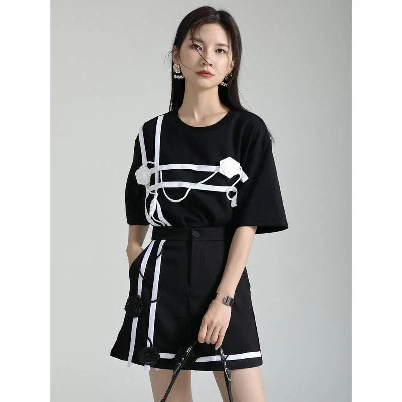 A stylish black and white floral half-sleeve casual t-shirt with a classic round neckline, perfect for everyday wear.