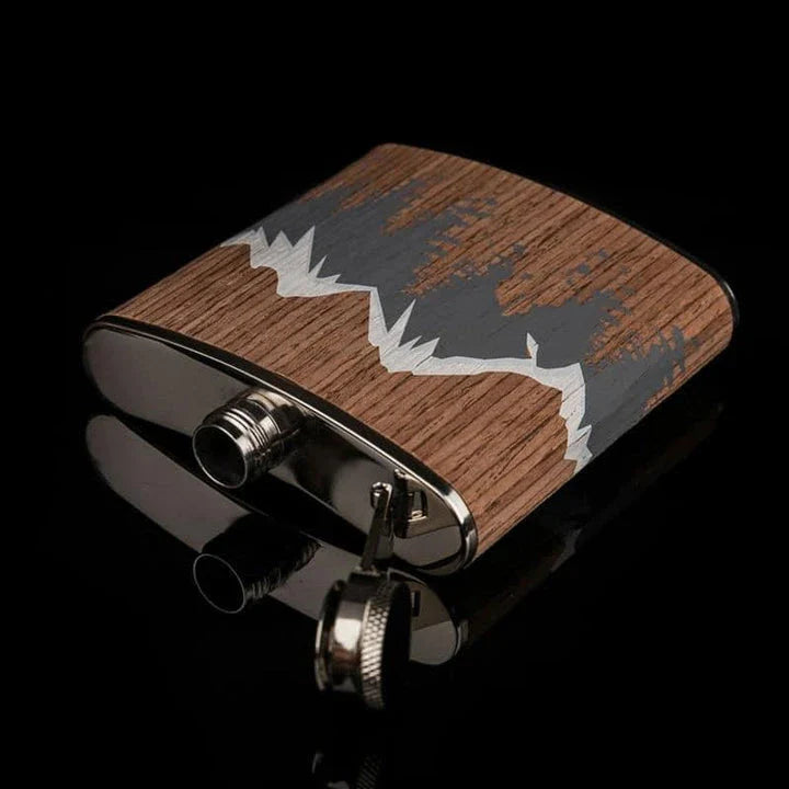 Stylish mountain-themed stainless steel and wood hip flask with optional glasses, perfect for outdoor adventures and social gatherings.