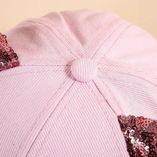A playful, embroidered kids' baseball cap in a vibrant red panda colour, featuring a cute cartoon cat design and shimmering sequin accents.