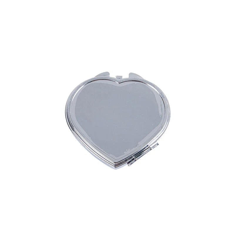 Elegant heart-shaped metal pill box with mirror for organized storage and convenient touch-ups