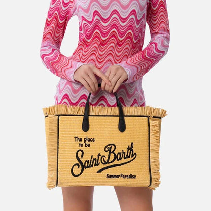 Stylish embroidered straw tote bag with playful tassels, perfect for summer outings and beach adventures.