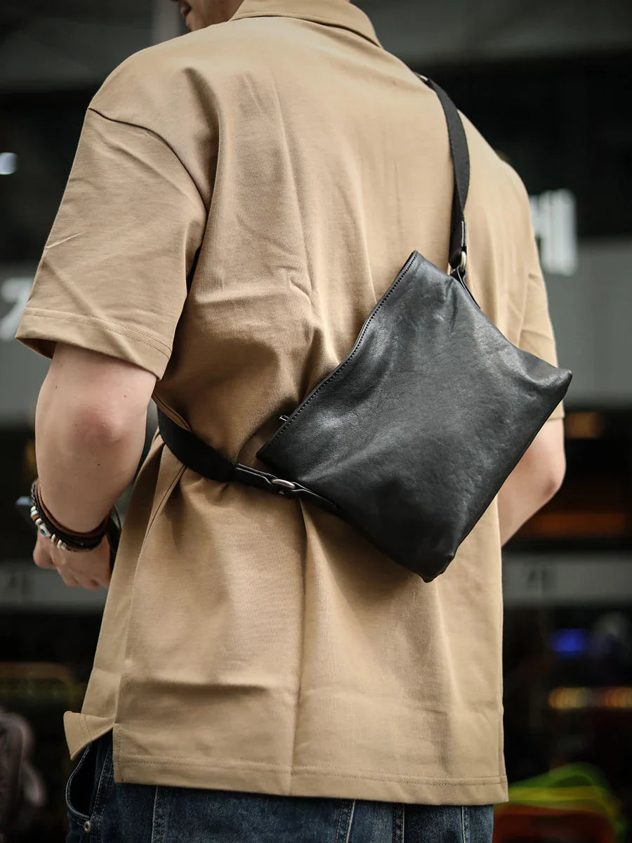 Premium black leather shoulder bag with horizontal zipper closure, featuring a spacious interior and versatile design for the modern British gentleman