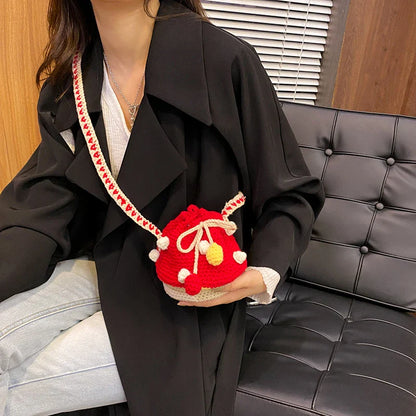 A stylish hand-knitted wool handbag in a compact mini size, featuring a unique woven design and adjustable strap for everyday use.