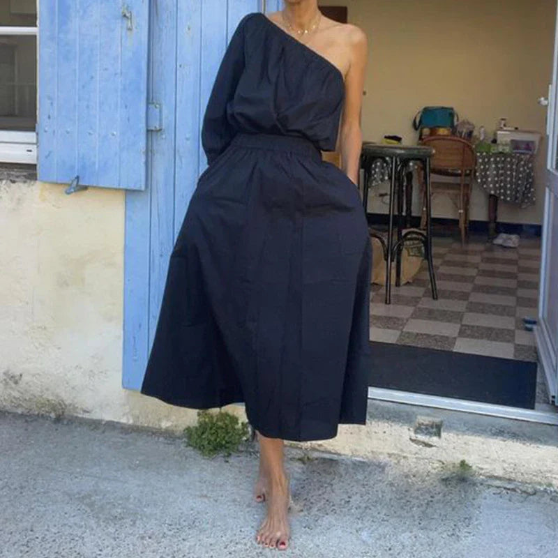Elegant two-piece mid-length skirt suit with oblique shoulder design, made with premium polyester fabric and boutique four-sided elastic band