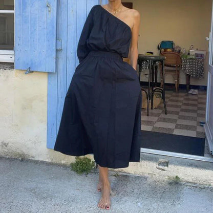Elegant two-piece mid-length skirt suit with oblique shoulder design, made with premium polyester fabric and boutique four-sided elastic band
