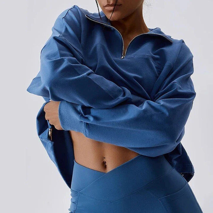 A cosy, oversized cotton pullover with a stylish zipper accent, perfect for casual autumn and winter wear.