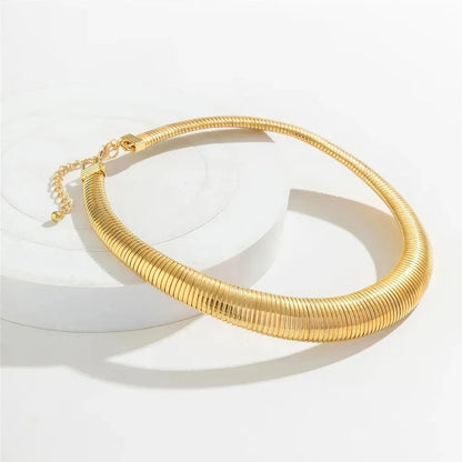Captivating spiral chunky choker necklace in gold and silver colours, featuring a bold, geometric design for a unique, statement-making look.
