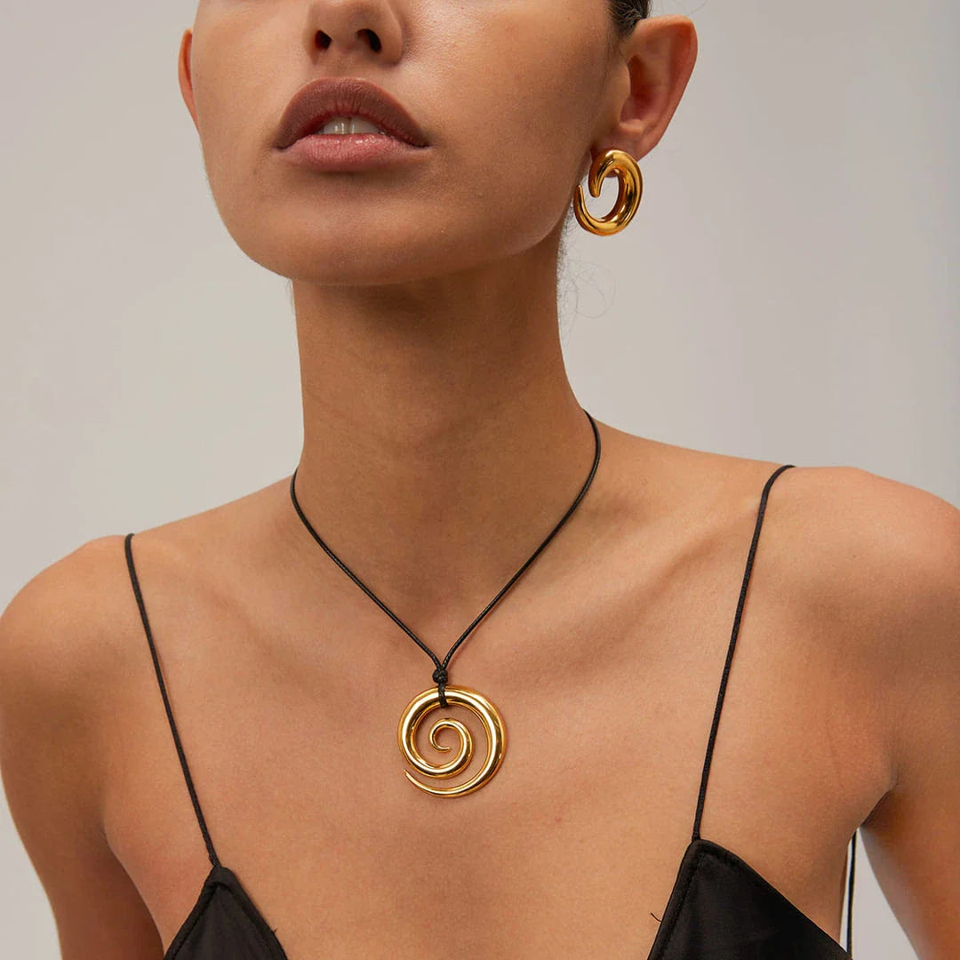 Exquisite spiral circle pendant necklace with 18K gold plating and black rope chain, a versatile accessory for the modern British woman.