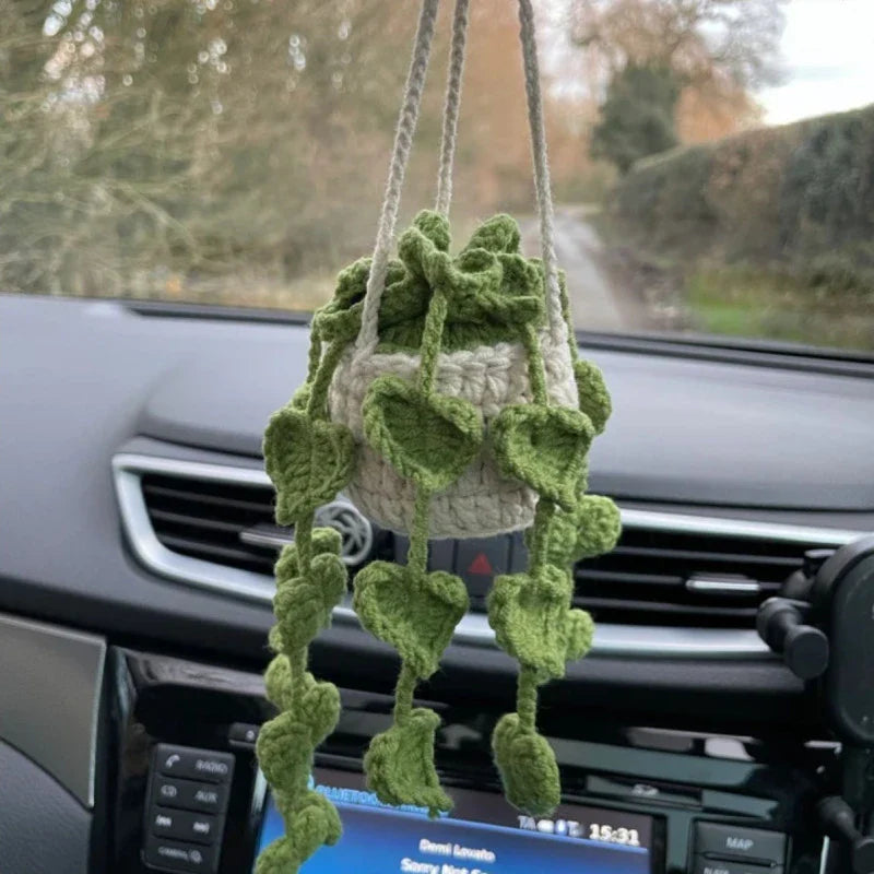 Charming knitted car plant decor with hanging white rope and green and white colour scheme
