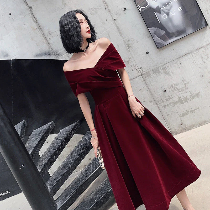 Off-shoulder wine red bridal dress with long, flowing skirt and tight waist for a sophisticated, elegant look