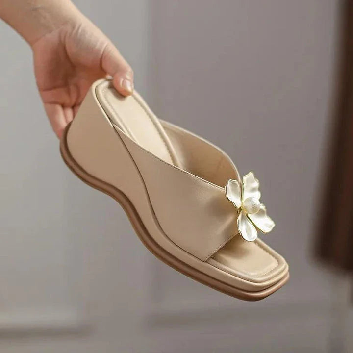 Elegant pearl flower wedge sandals in beige colour, featuring a thick, cushioned platform and adjustable straps for a comfortable fit.