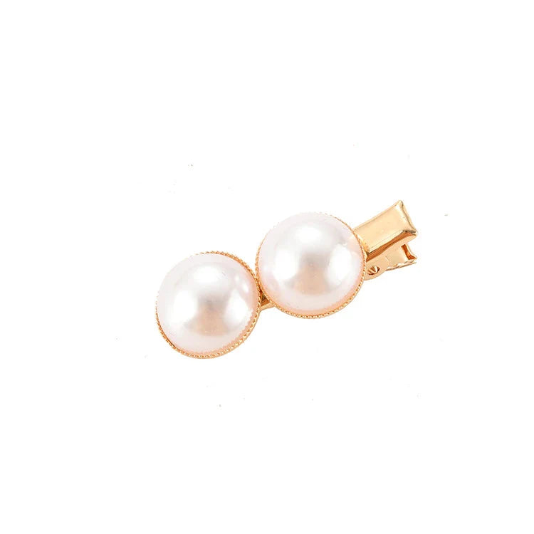 Elegant silver-toned hair clip with a beautiful pearl flower design, a timeless British-inspired accessory