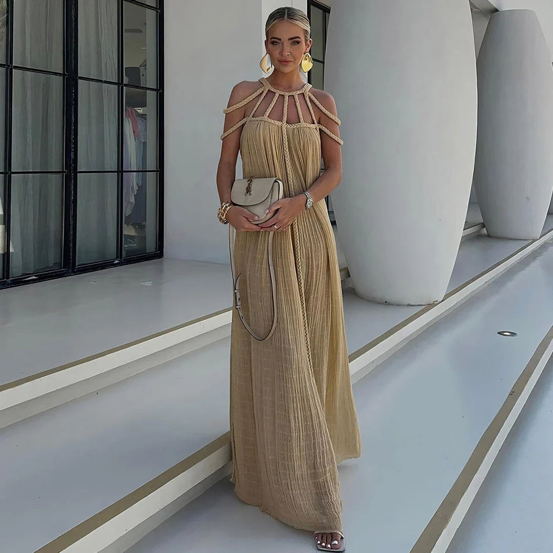A stylish and sophisticated hollow out knitted beach dress in a beige colour, perfect for summer beach and poolside wear.