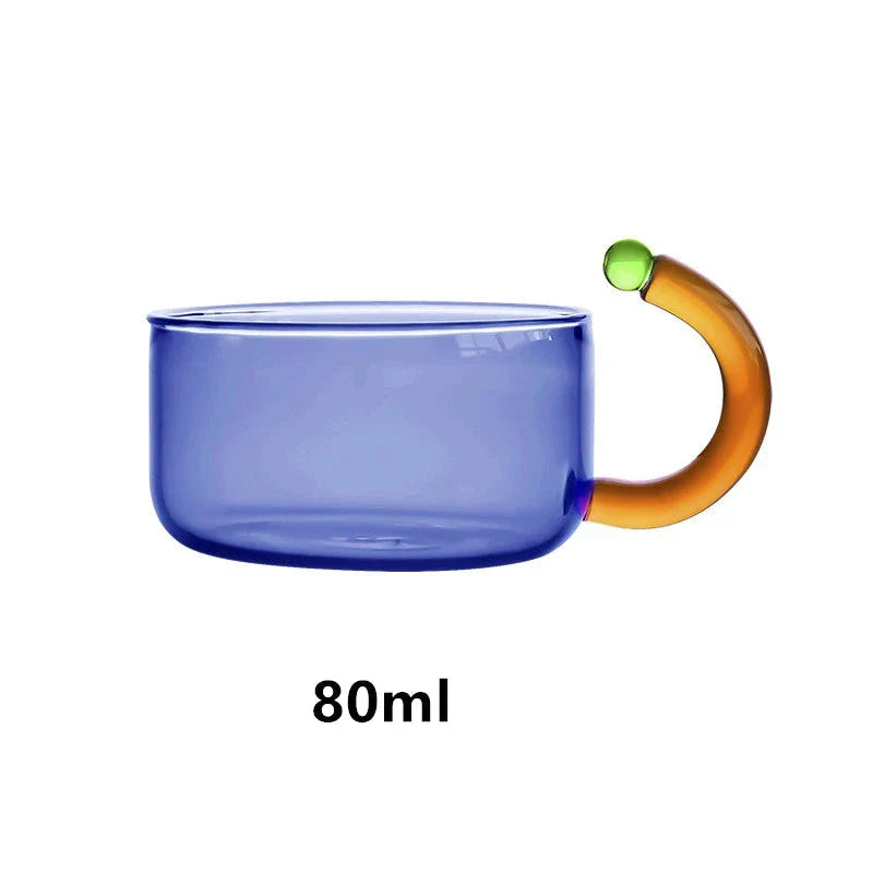 Elegant colourful glass teapot and teacup set with vibrant contrasting colours, perfect for tea and coffee enjoyment