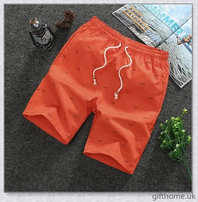 Pair of premium cotton beach shorts in navy blue, khaki, and slate grey colours, perfect for stylish seaside adventures