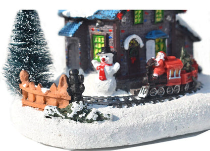 Luminous Christmas house decorations made of resin, with a warm glowing light creating a festive winter scene