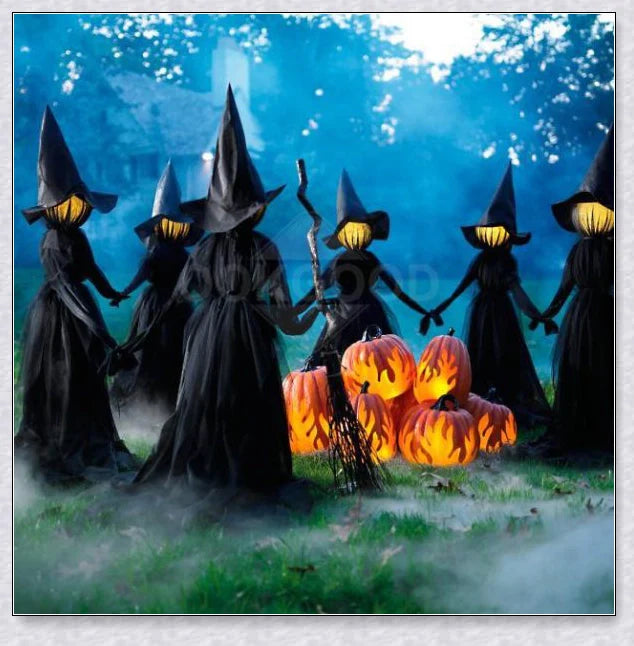 Three tall, black-robed witch figures with faceless glowing heads, standing together and holding hands, creating a spooky outdoor Halloween display