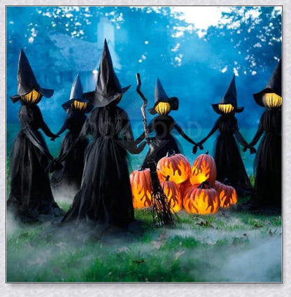 Three tall, black-robed witch figures with faceless glowing heads, standing together and holding hands, creating a spooky outdoor Halloween display