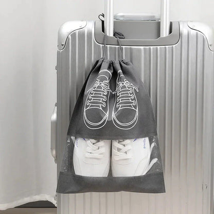 A set of grey travel shoe storage organiser bags with transparent panels for easy identification of contents
