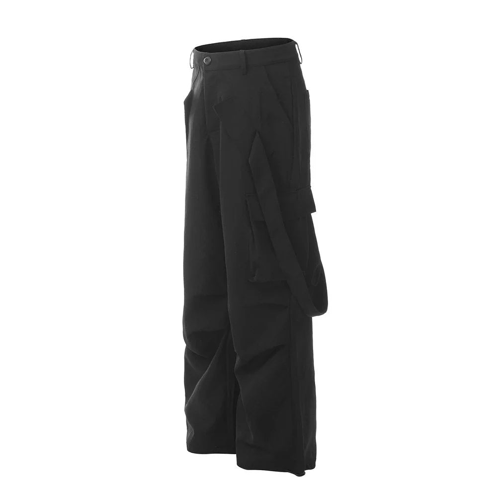 Stylish black pleated overalls with ribbon pockets, a versatile and refined menswear piece.
