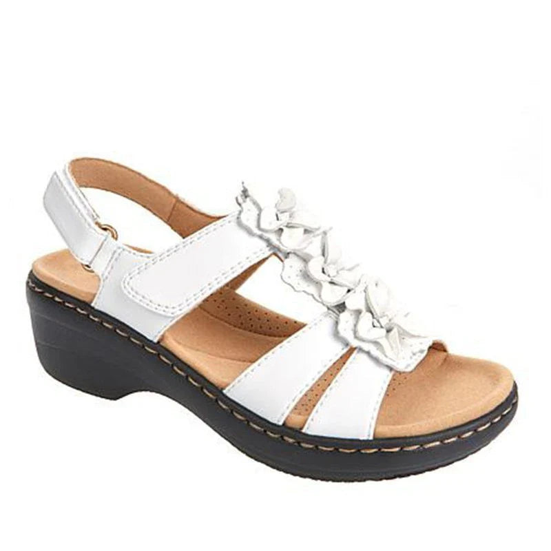 Stylish wedge sandals in a range of vibrant colours, featuring a chic fish mouth design and delicate flower accents for a modern, casual-chic look.