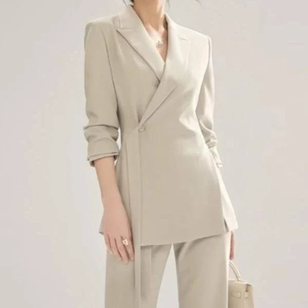 A two-piece vintage-inspired office suit with a long-sleeve blazer and high-waisted trousers, designed for the modern professional woman.