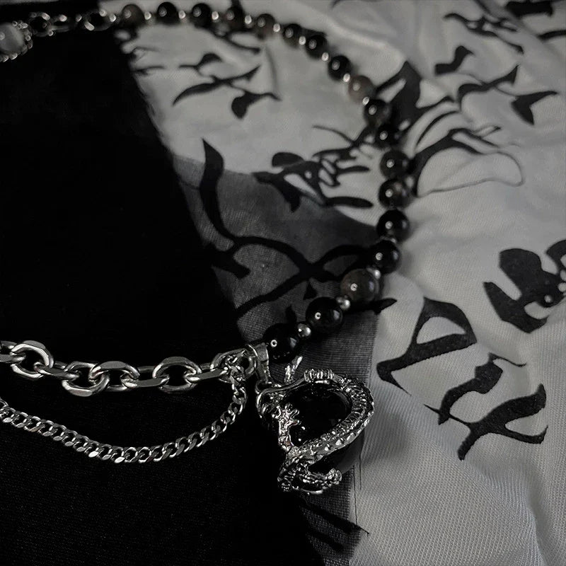 Titanium steel necklace with a black agate pendant featuring an intricate dragon design