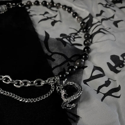 Titanium steel necklace with a black agate pendant featuring an intricate dragon design