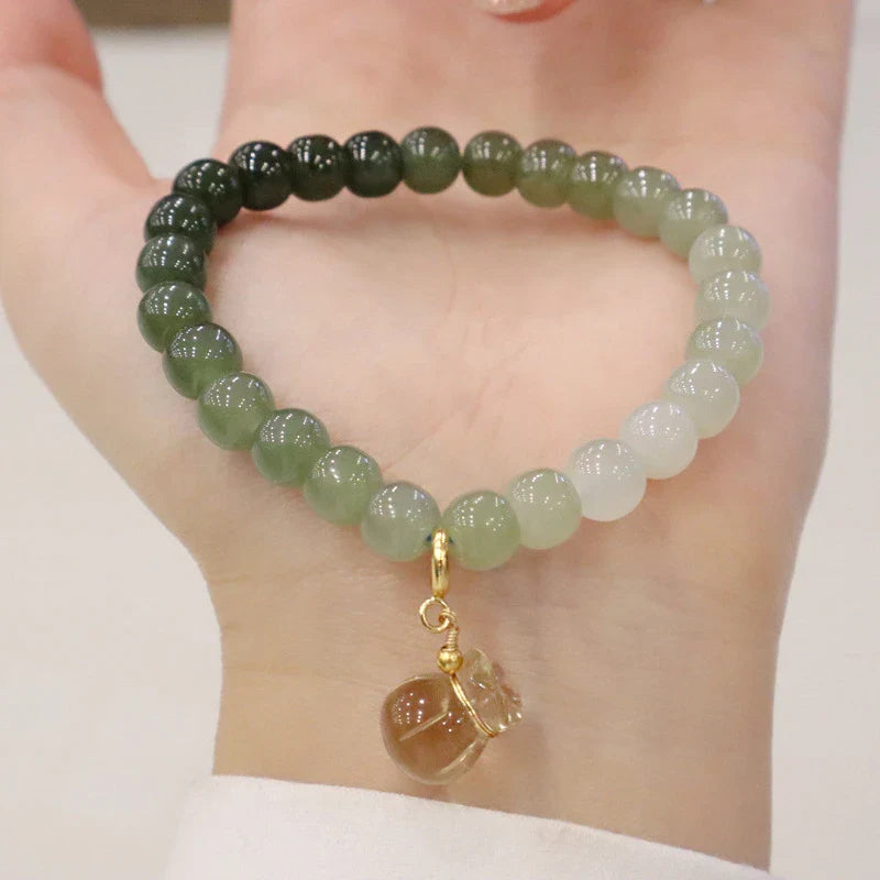 Elegant Hetian jade barrel bead bracelet with gradual colour transition, handcrafted with premium materials for a sophisticated style.