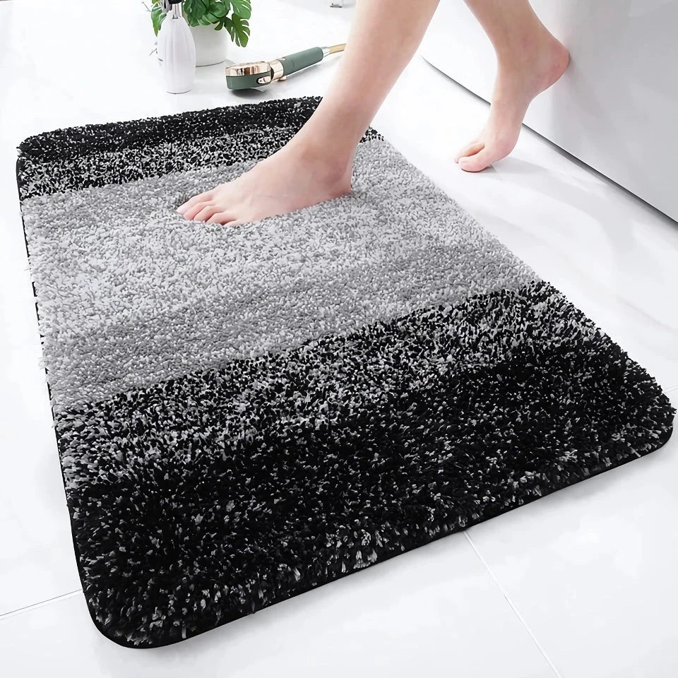 Luxurious microfibre absorbent bath mat with soft, plush texture and non-slip rubber backing for comfort and safety in the bathroom