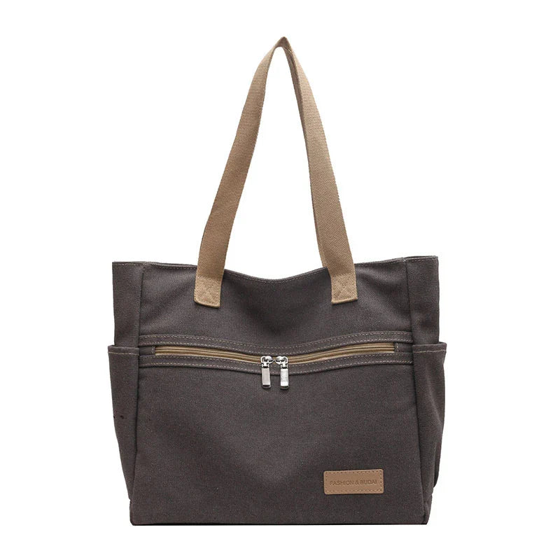 Premium canvas shoulder bag in grey, khaki, and green colours, featuring a stylish and functional design for everyday use.
