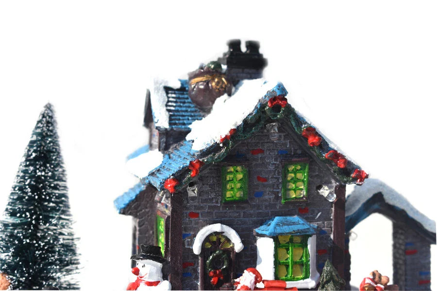Luminous Christmas house decorations made of resin, with a warm glowing light creating a festive winter scene