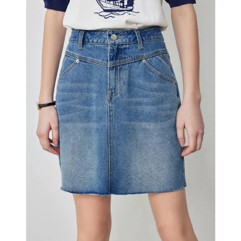 Sophisticated lyocell denim mini skirt with classic A-line silhouette and functional pockets for the discerning British woman