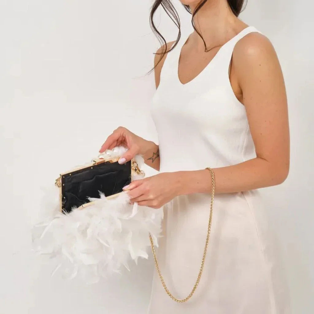 Elegant feather clutch purse with lustrous pearls, metal chains, and a top handle design