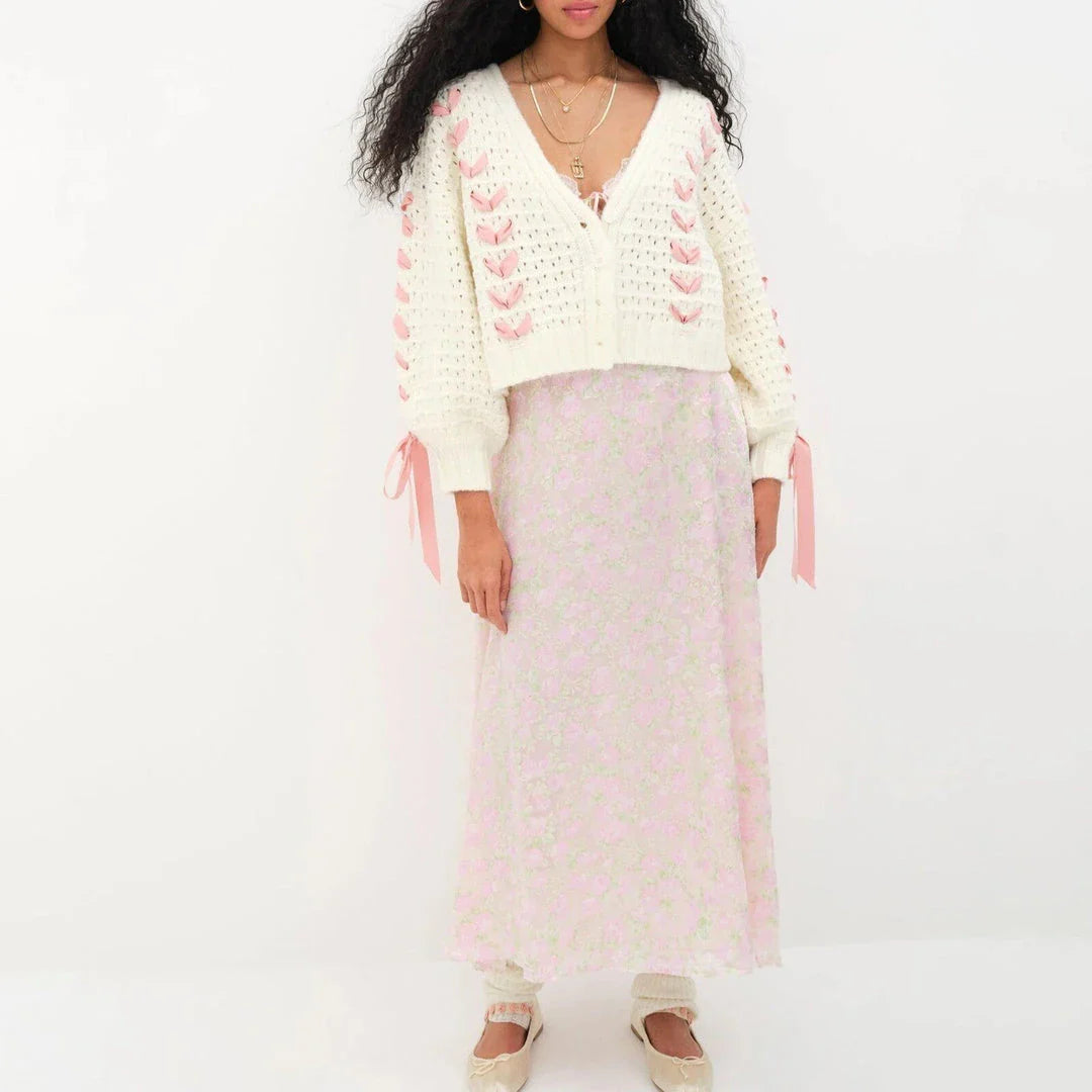 A versatile contrast V-neck tie cardigan in a soft, polyester fabric with a patchwork pattern and lace-up detail for a fashionable and comfortable layering piece.