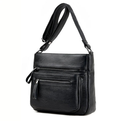 A stylish leather shoulder bag in a modern, box-style design, perfect for busy modern mums.