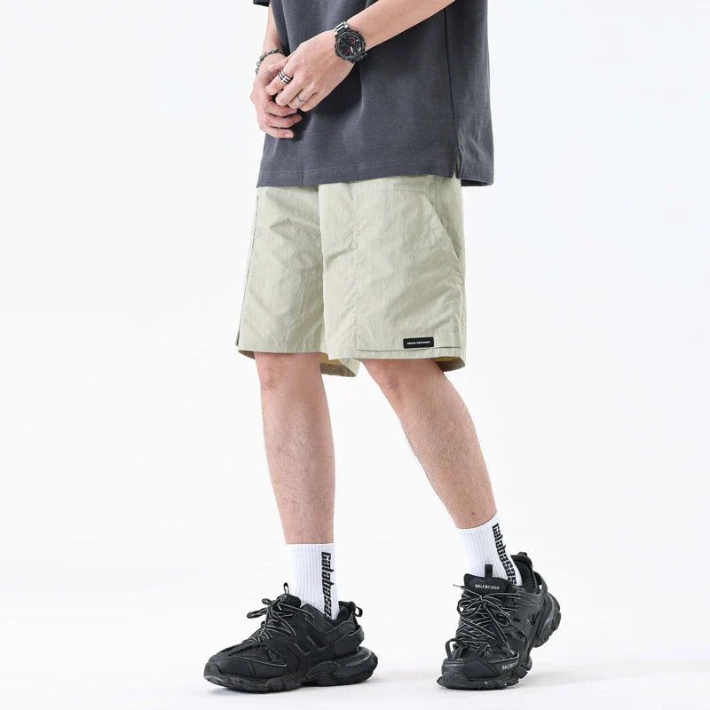 Premium men's quick-drying casual trousers in black, caramel, and sand colours with a relaxed, loose fit