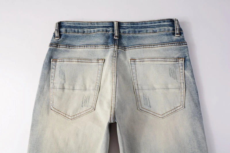 Stylish distressed denim jeans with a skinny, knee-exposed silhouette for a contemporary, high-street fashion look