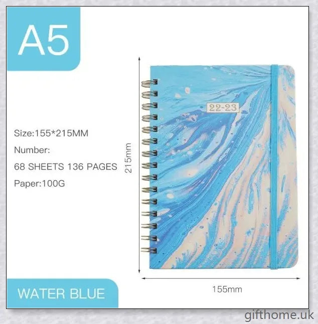 Premium A5 spiral-bound annual calendar notebook with a variety of stylish cover designs including blue art, pink roses, and colourful floral patterns