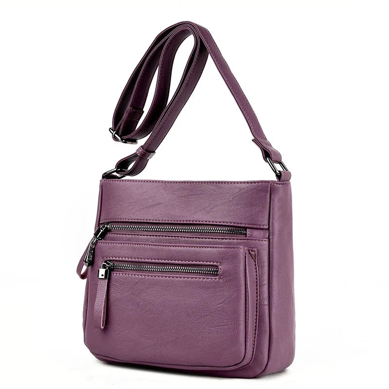 A stylish leather shoulder bag in a modern, box-style design, perfect for busy modern mums.