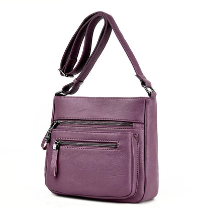 A stylish leather shoulder bag in a modern, box-style design, perfect for busy modern mums.