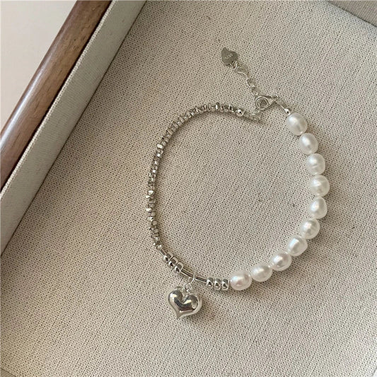 Elegant heart-shaped pearl necklace in sterling silver, a timeless British-inspired accessory