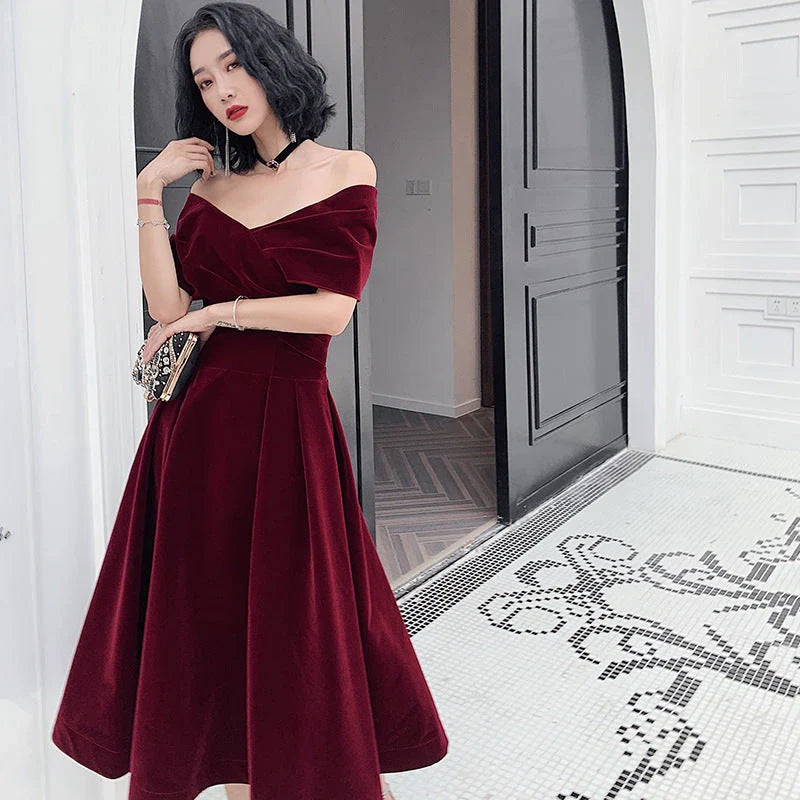 Off-shoulder wine red bridal dress with long, flowing skirt and tight waist for a sophisticated, elegant look