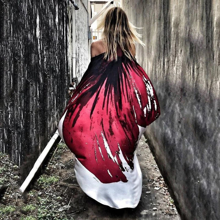 A chic inclined shoulder printed dress in a vibrant colour with a large, swinging skirt