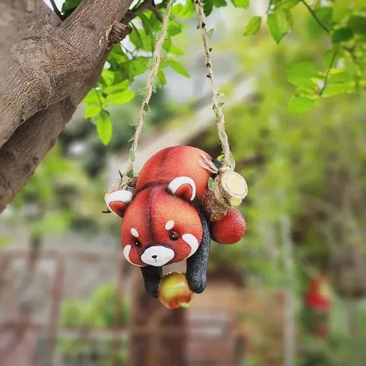 Charming resin raccoon statue climbing a decorative rope, adding a whimsical and nature-inspired touch to your outdoor or indoor spaces