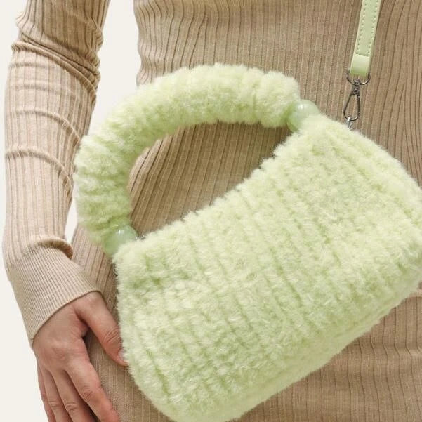 A luxurious faux fur hobo handbag with a stylish baguette shape and secure zipper closure