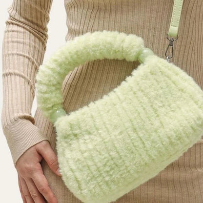 A luxurious faux fur hobo handbag with a stylish baguette shape and secure zipper closure