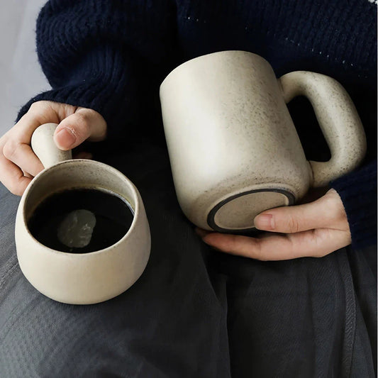Handcrafted Japanese ceramic retro coffee mug in solid apricot or grey colour, featuring a comfortable handgrip design for enhanced daily beverage enjoyment.