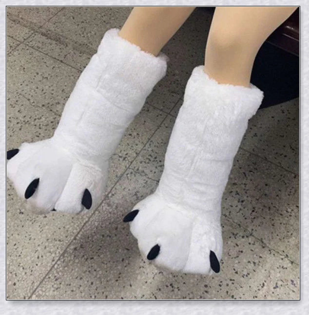 Cosy and whimsical oversized bear paw winter slippers with a plush, fluffy design and non-slip sole for secure indoor wear